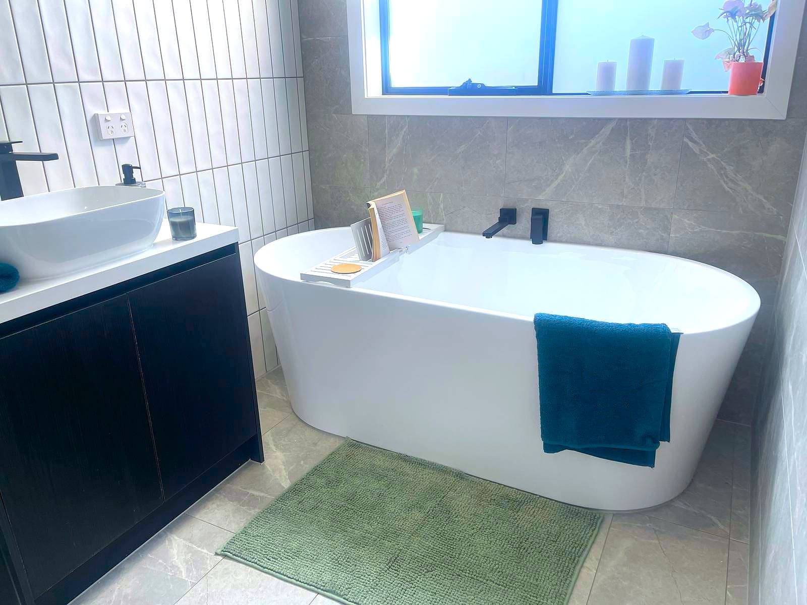 Bathroom at the Deanside home with a freestanding bath and vanity.