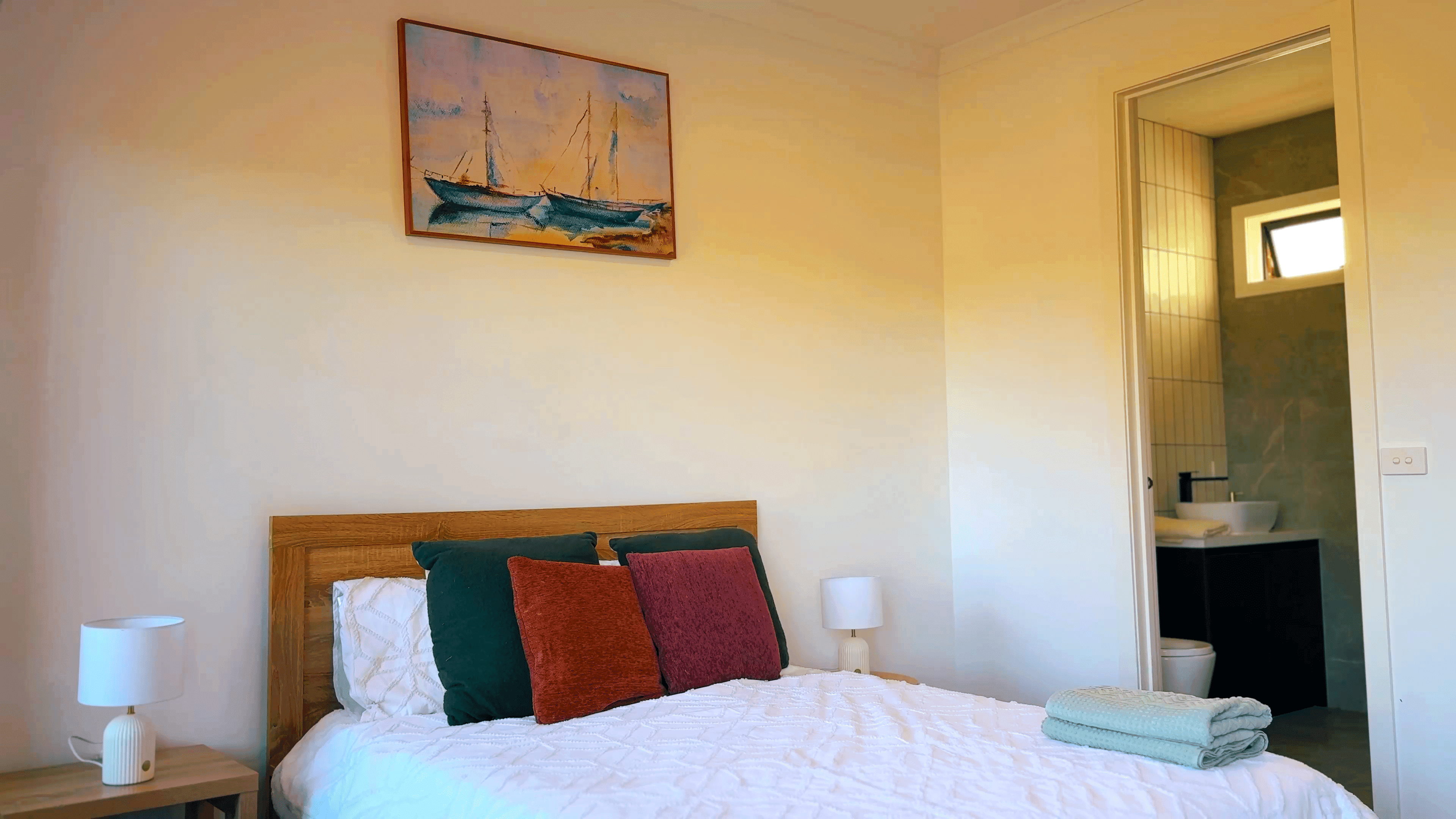 A bedroom at the Deanside home with a double bed and a doorway through to an ensuite.