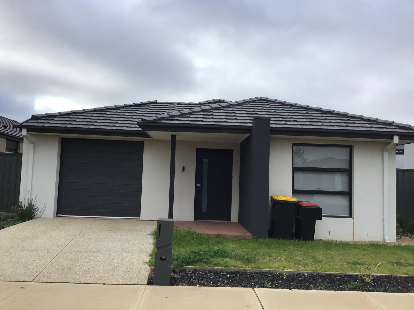 Exterior of the Gencare High Physical Support SDA home in Cobblebank, a single-storey house with a tiled roof and a wide concrete driveway.